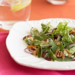 Baby green salad with orange vinaigrette, blue cheese and toasted pecans