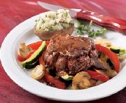 Beef medaillons on a bed of vegetables with red wine sauce